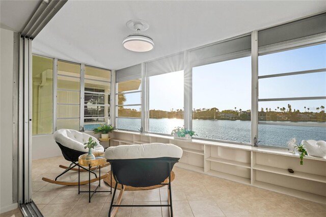 sunroom featuring a healthy amount of sunlight and a water view