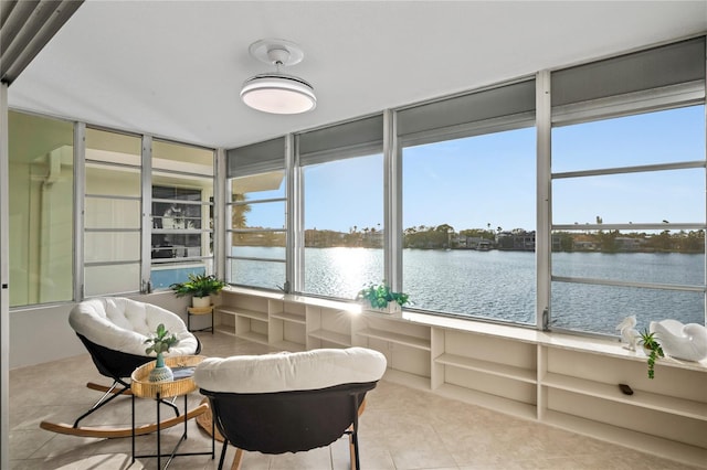 sunroom / solarium featuring a healthy amount of sunlight and a water view