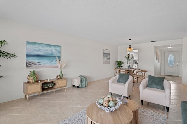 living area featuring light tile patterned flooring and visible vents