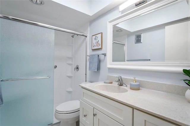 full bathroom featuring toilet, a shower with door, and vanity