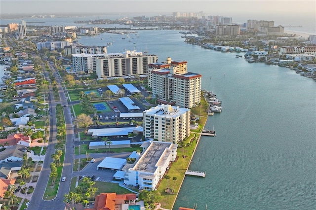 birds eye view of property with a water view and a view of city