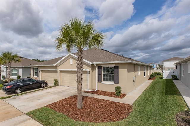 view of front of property featuring a front yard and a garage