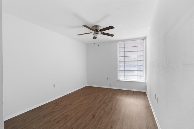 unfurnished room with ceiling fan and dark hardwood / wood-style floors