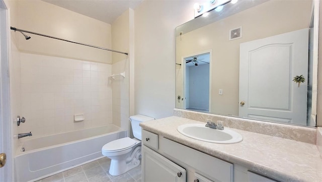 full bathroom featuring tiled shower / bath combo, toilet, vanity, ceiling fan, and tile floors