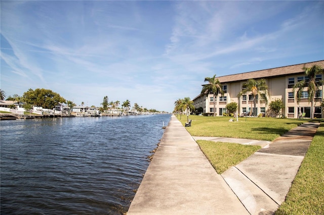 exterior space with a water view and a yard