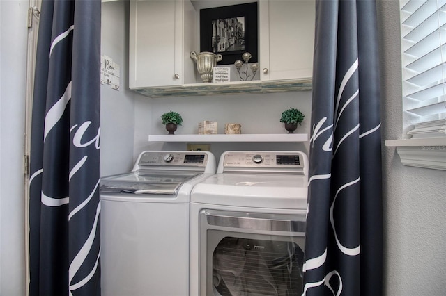 laundry area featuring cabinets and separate washer and dryer