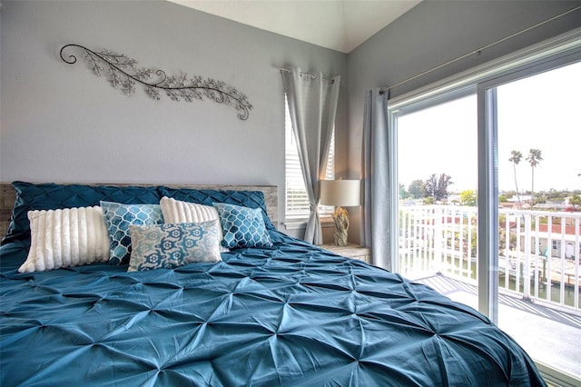 bedroom featuring access to outside and vaulted ceiling