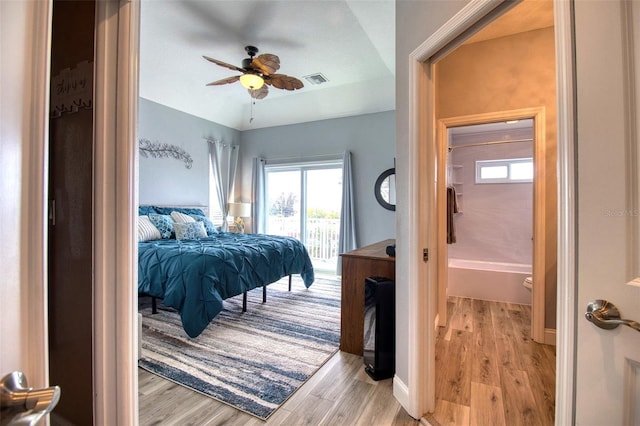 bedroom featuring light wood-type flooring, access to outside, visible vents, and baseboards