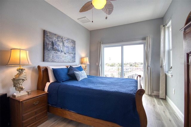 bedroom featuring visible vents, ceiling fan, wood finished floors, access to outside, and baseboards