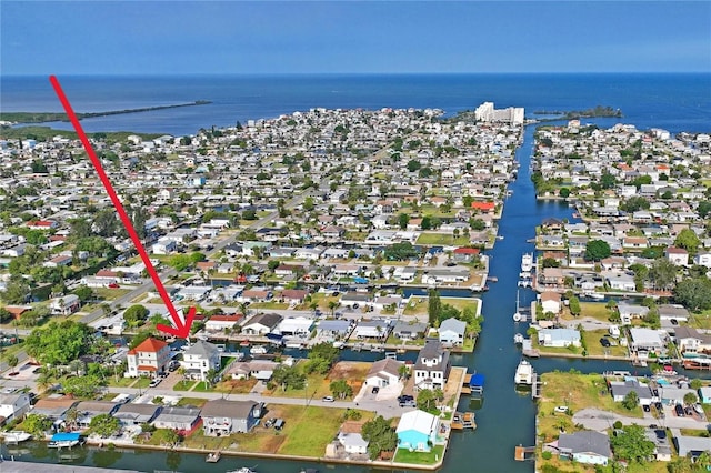 drone / aerial view featuring a water view and a residential view