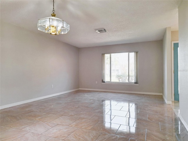 empty room with baseboards, a textured ceiling, visible vents, and an inviting chandelier