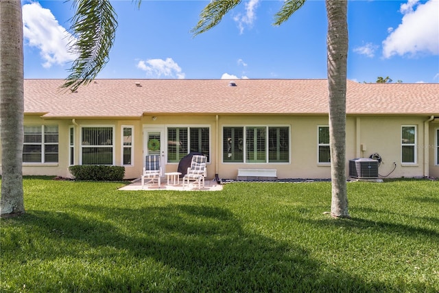 back of property featuring a patio area, central AC, and a lawn