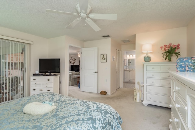 carpeted bedroom with access to exterior, ensuite bath, ceiling fan, and a textured ceiling