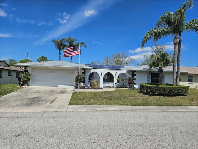 ranch-style house featuring a front yard and a garage