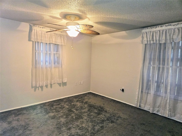 carpeted empty room with a textured ceiling and ceiling fan