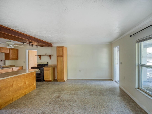 unfurnished living room with ceiling fan, sink, and beamed ceiling