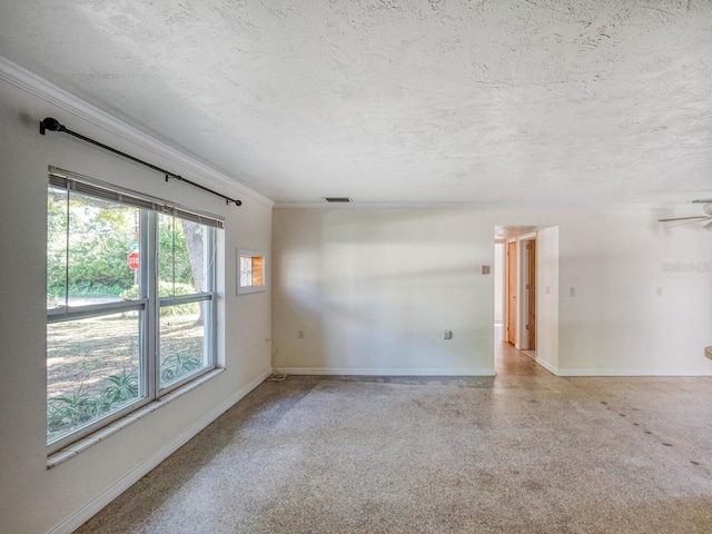 spare room with crown molding, a textured ceiling, and ceiling fan