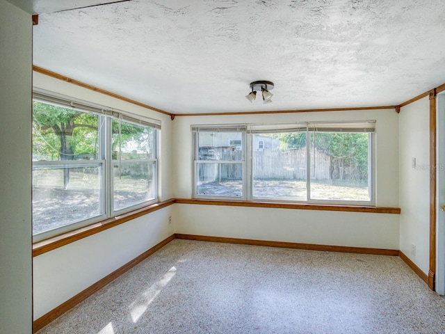 unfurnished room featuring a textured ceiling