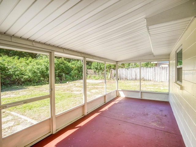 unfurnished sunroom featuring lofted ceiling