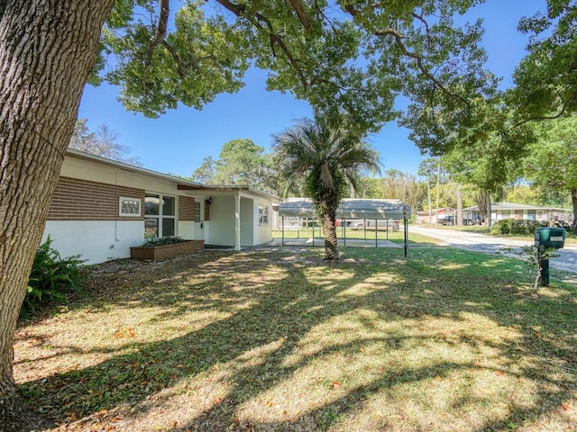 view of yard with a carport