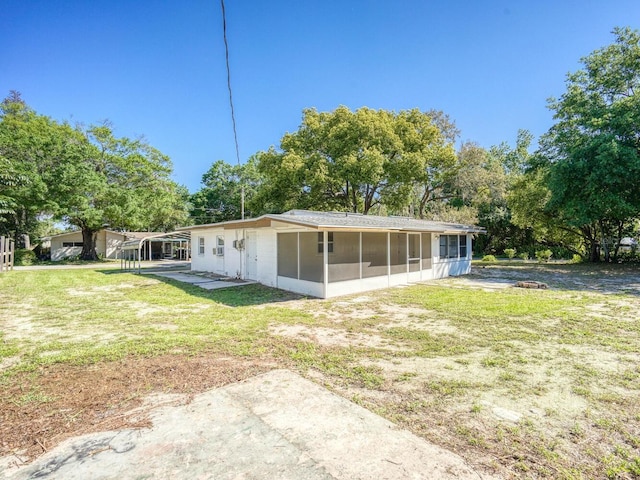 back of house with a lawn