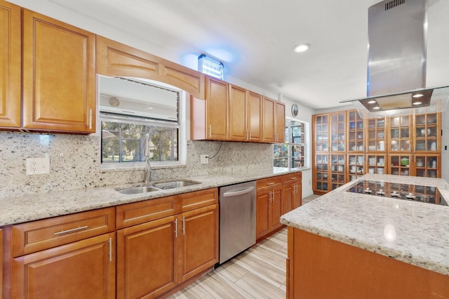 kitchen featuring exhaust hood, light stone countertops, dishwasher, and sink