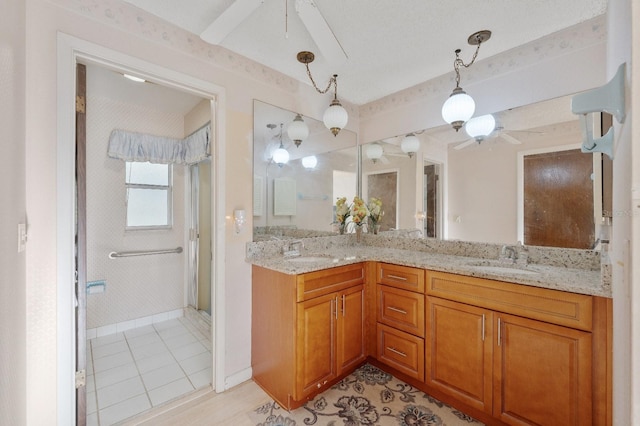 bathroom featuring dual vanity, ceiling fan, and tile floors