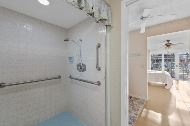 bathroom with hardwood / wood-style floors, a textured ceiling, and ceiling fan