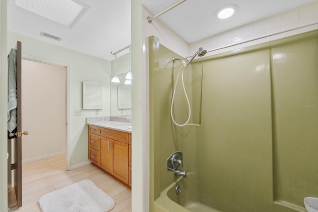 bathroom featuring vanity, shower / bathtub combination, and hardwood / wood-style flooring