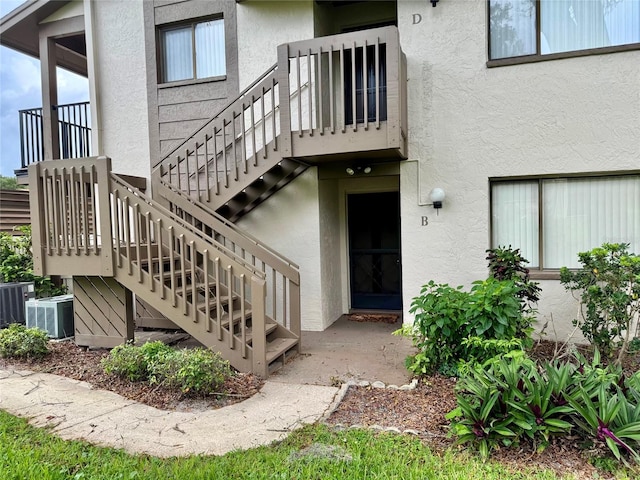 entrance to property featuring cooling unit