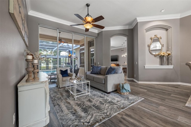 living room featuring dark hardwood / wood-style flooring, ceiling fan, and ornamental molding