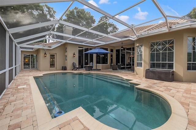 view of pool with a lanai and a patio