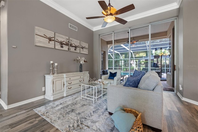 living room featuring crown molding, plenty of natural light, and wood-type flooring