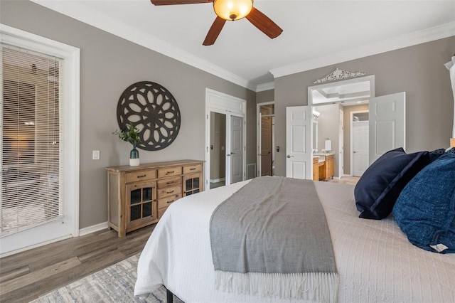 bedroom featuring ceiling fan, wood-type flooring, ornamental molding, and connected bathroom