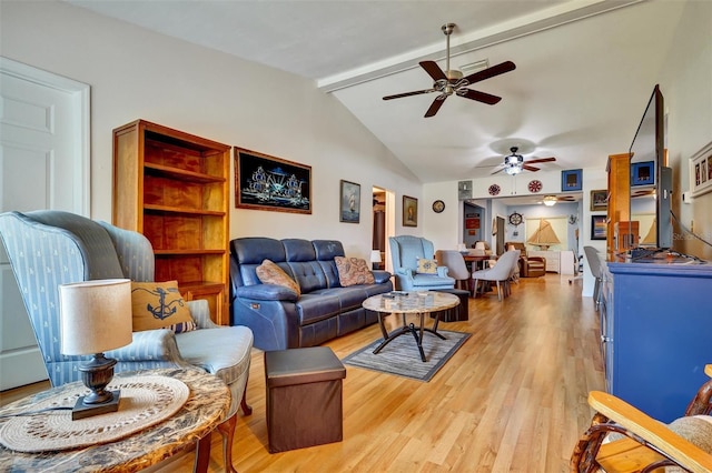 living room with lofted ceiling with beams, ceiling fan, and light wood-type flooring