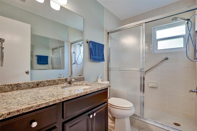 bathroom with tile flooring, a shower with door, toilet, and oversized vanity