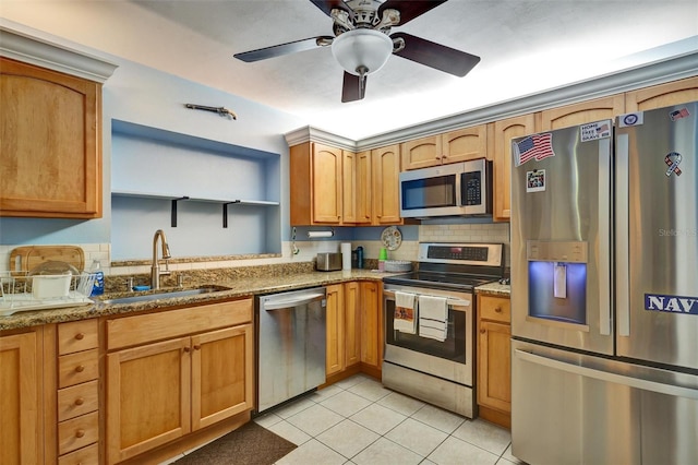 kitchen featuring appliances with stainless steel finishes, ceiling fan, stone counters, light tile floors, and sink