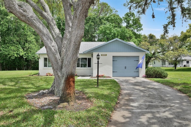 ranch-style home with a front lawn and a garage