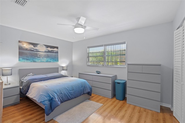 bedroom with ceiling fan and light hardwood / wood-style floors