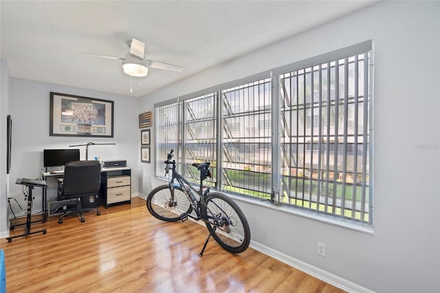 office featuring a textured ceiling, hardwood / wood-style flooring, and ceiling fan