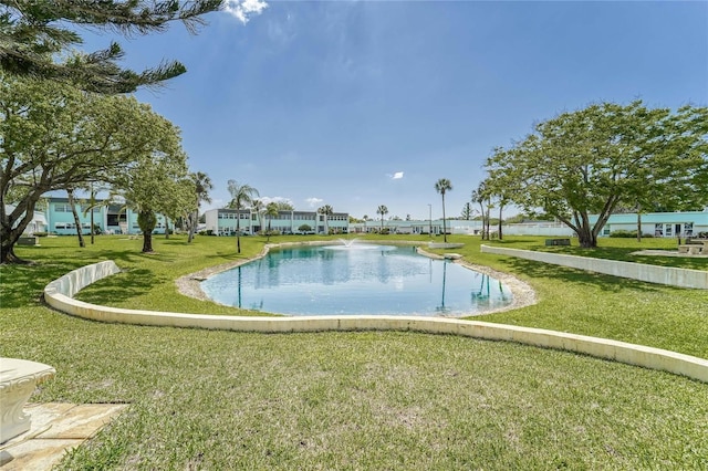 view of swimming pool with a yard