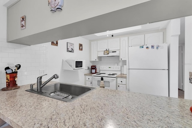 kitchen with light stone counters, sink, white appliances, tasteful backsplash, and white cabinetry