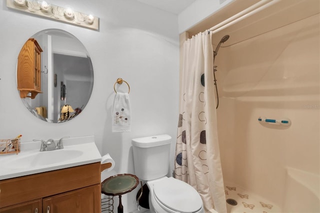 bathroom featuring curtained shower, vanity, and toilet