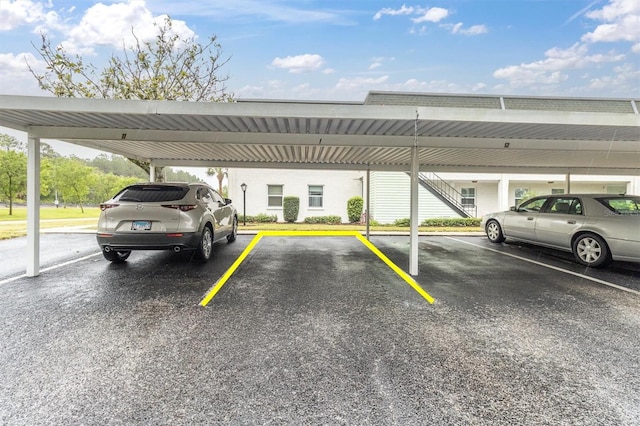 view of vehicle parking with a carport