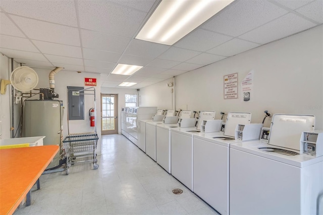 clothes washing area with light tile floors and washer and clothes dryer