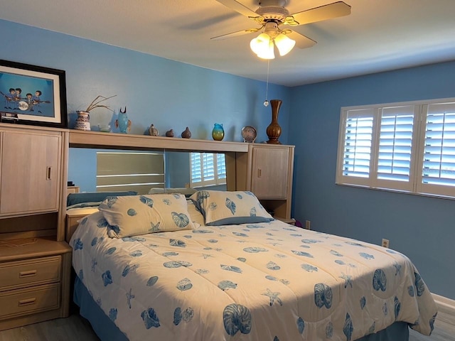 bedroom with hardwood / wood-style flooring and ceiling fan