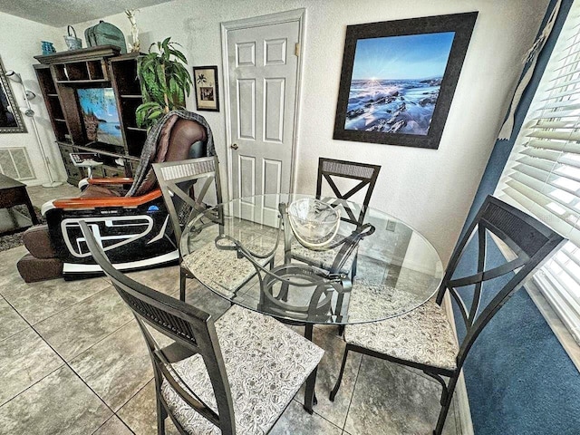 dining space with tile floors