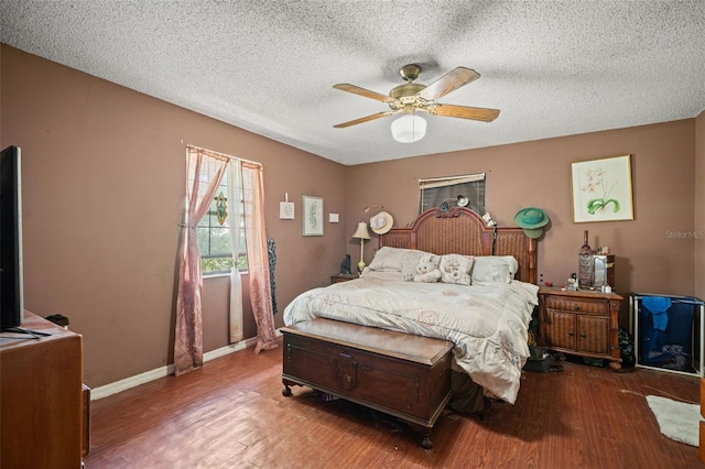 bedroom featuring ceiling fan, hardwood / wood-style flooring, and a textured ceiling