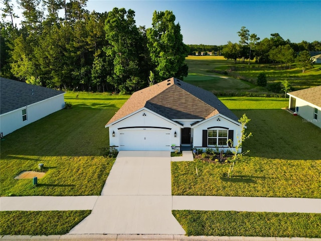 view of front of property featuring a front lawn and a garage