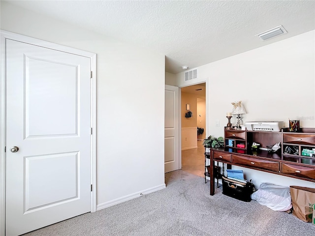 office with tile floors and a textured ceiling